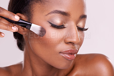 Buy stock photo Beauty, makeup and black woman with brush on face in studio with cosmetic application tool. Skincare, blush and cosmetics, facial skin care model with luxury contour powder product on pink background