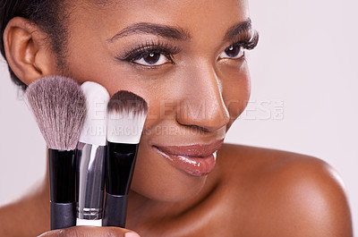 Buy stock photo Cosmetic brushes, makeup and black woman with smile on face in studio and beauty application tool. Skincare, blush and cosmetics, facial skin model with luxury contour product on white background
