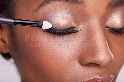 Buy stock photo Black woman, closeup of face and brush for eyeshadow with makeup, beauty and lashes on pink background. Skin glow, cosmetics product and tools for cosmetology, shimmer or glitter with shine in studio