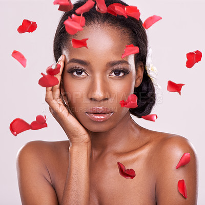 Buy stock photo Portrait, beauty and petals with natural black woman in studio on pink background for wellness. Face, skincare and cosmetics with serious young aesthetic model at spa for dermatology treatment