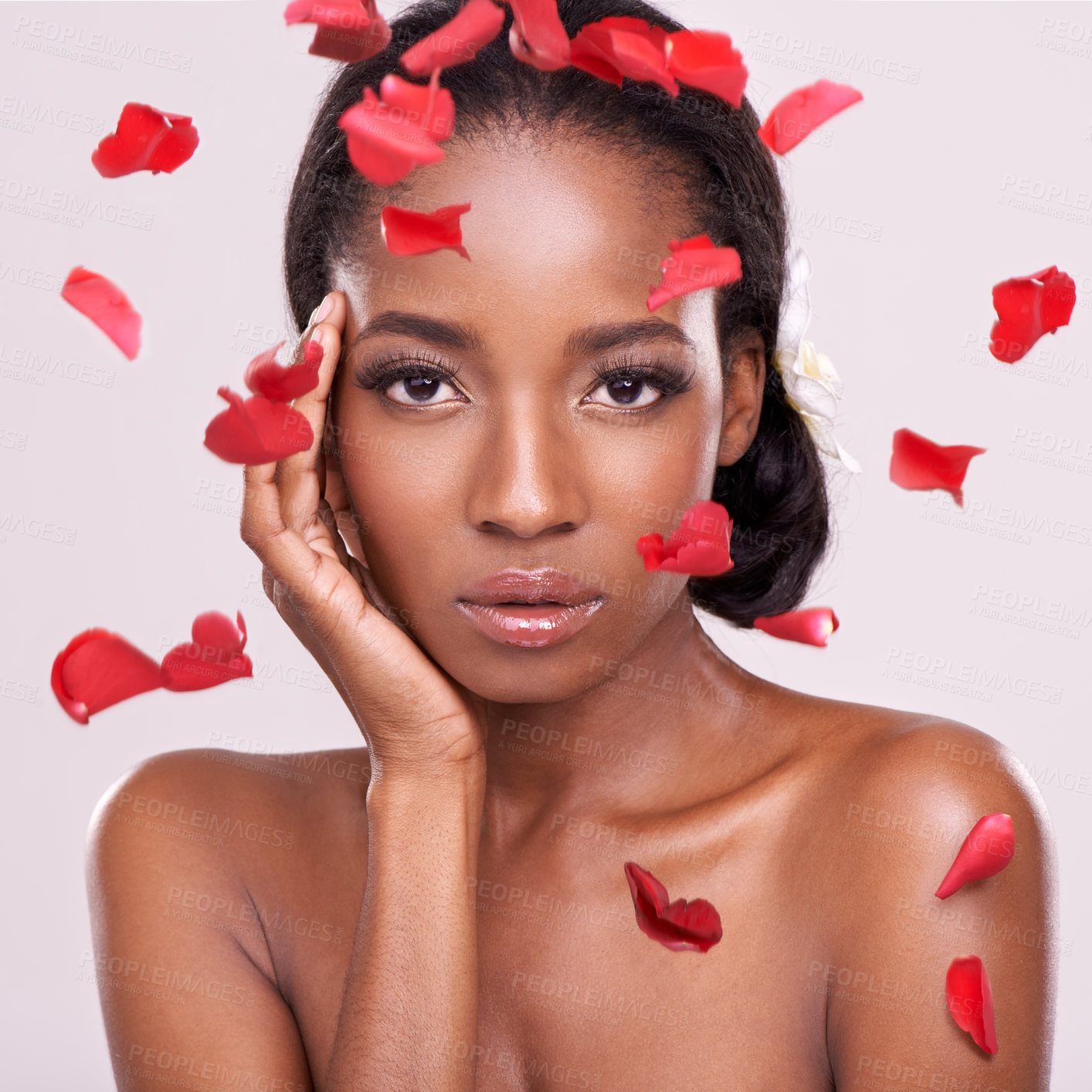 Buy stock photo Portrait, beauty and petals with natural black woman in studio on pink background for wellness. Face, skincare and cosmetics with serious young aesthetic model at spa for dermatology treatment