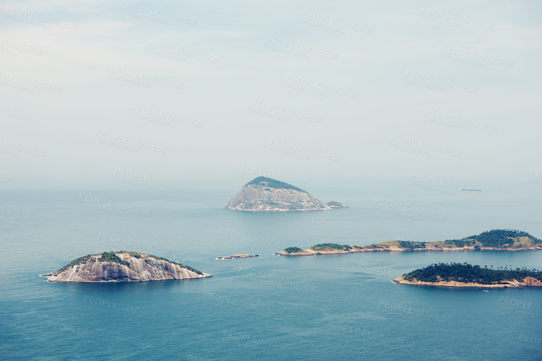 Buy stock photo Ocean, nature and aerial of island in sea for travel, holiday and vacation destination in summer. Natural background, seascape and islands in water for scenic view in environment, ecosystem and waves