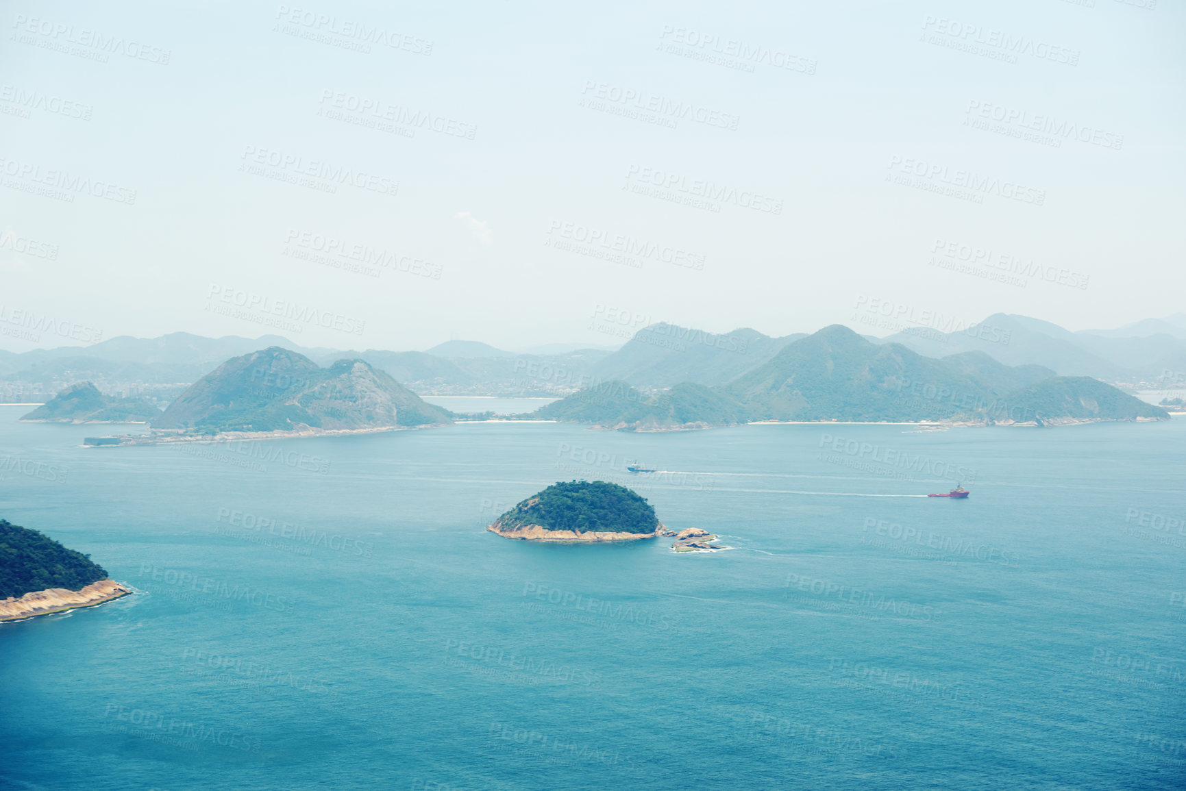 Buy stock photo Ocean, nature and aerial of island for travel, holiday and vacation destination in summer. Natural background, seascape and rock islands in water for scenic view in environment, ecosystem and waves