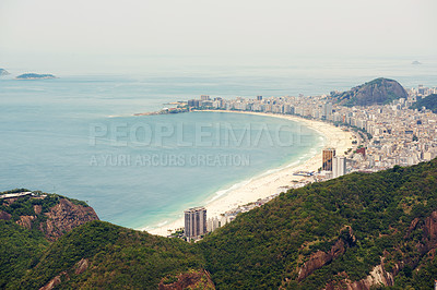 Buy stock photo Cropped shot of a city on the coastline with mountains surrounding it