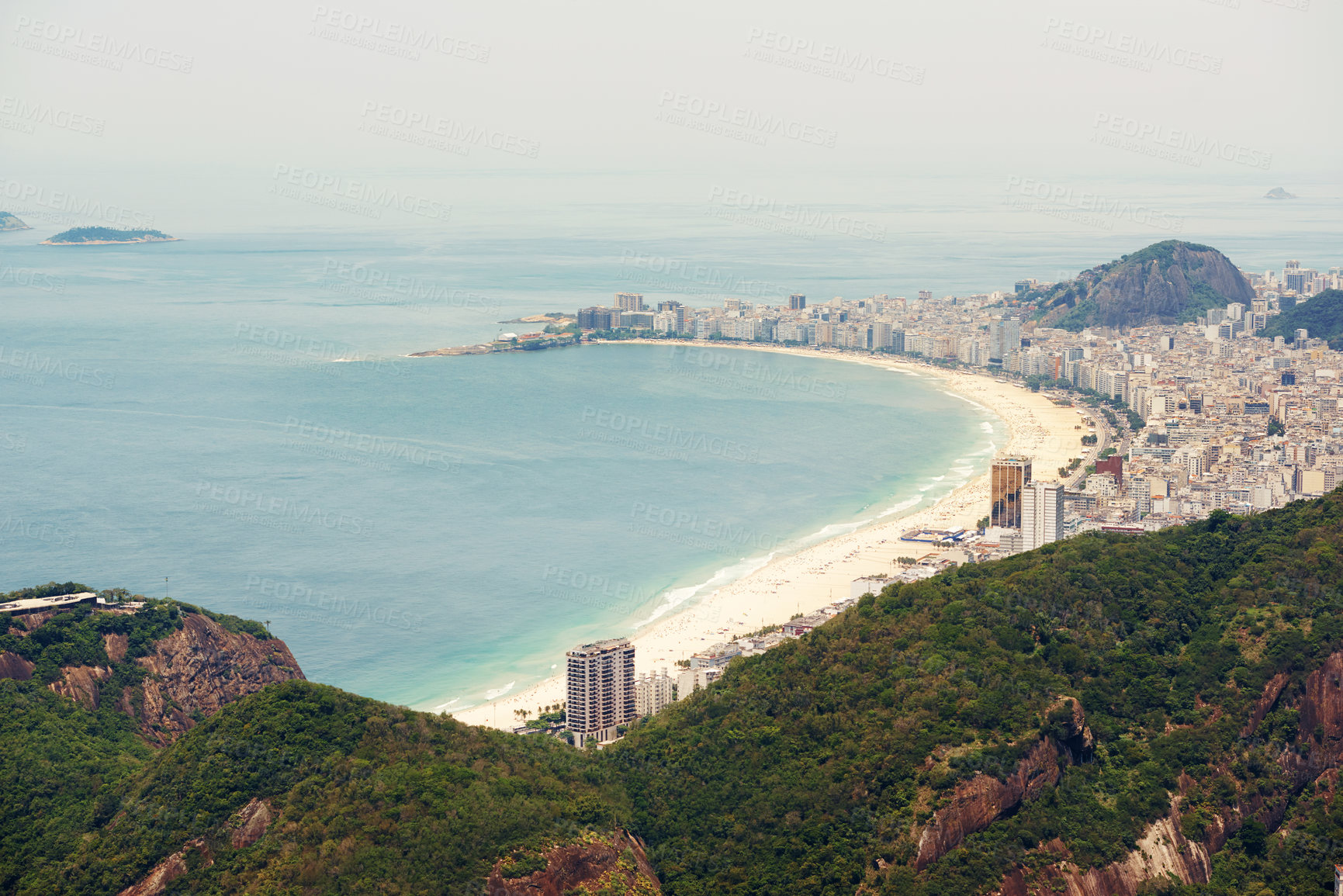 Buy stock photo Cropped shot of a city on the coastline with mountains surrounding it