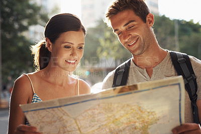 Buy stock photo Happy couple, tourism and city with map for destination, location or tour guide on street or road. Man and woman looking at paper with smile for directions, travel route or outdoor path in urban town