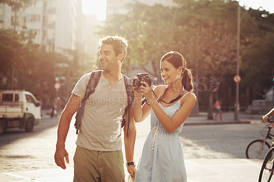Buy stock photo Couple, tourist and photography in street for travel, sightseeing and happiness on holiday or vacation in Brazil. Camera, man and woman with smile in city road for explore, tourism or journey in town