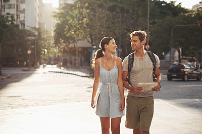 Buy stock photo Cropped shot of a loving young couple touring a foreign city