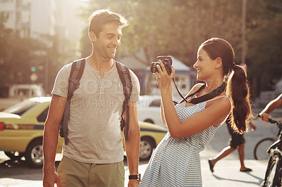 Buy stock photo Couple, tourism and photography in street for travel, sightseeing and happiness on holiday or vacation in Brazil. Camera, man and woman with smile in city road for explore, tourist or journey in town