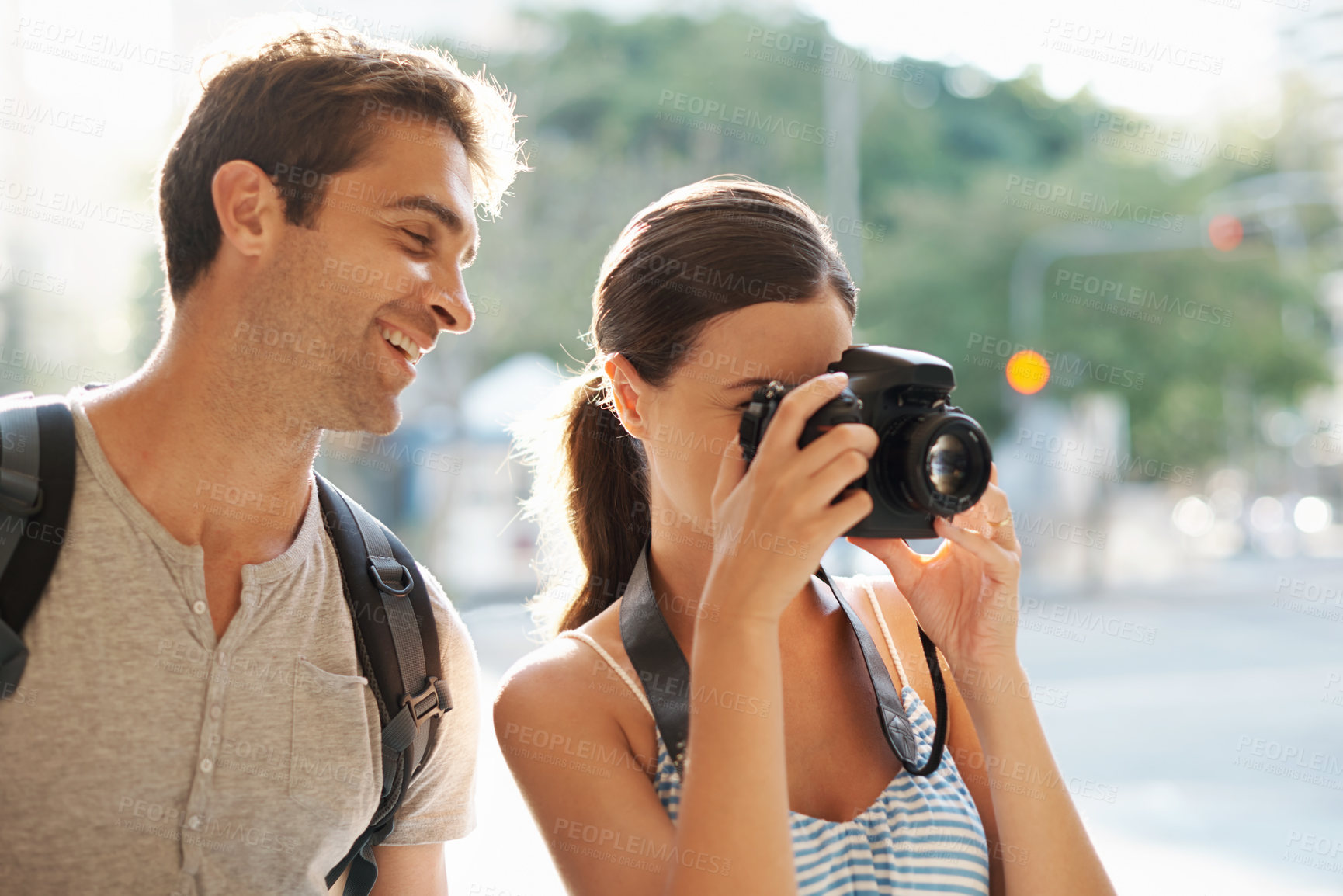 Buy stock photo Couple, tourist and photographer in street for travel, sightseeing or happiness on holiday or vacation in Brazil. Camera, man and woman with smile in city road for explore, tourism or journey in town