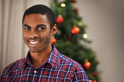 Buy stock photo Man, portrait and happy in home on christmas for celebration, holiday and festive spirit in living room. African person, face and smile on xmas with relax, confidence and vacation in lounge of house