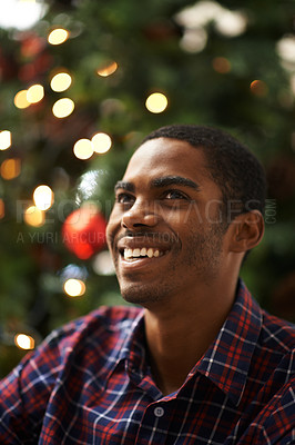 Buy stock photo Shot of a handsome young man getting into the Christmas spirit