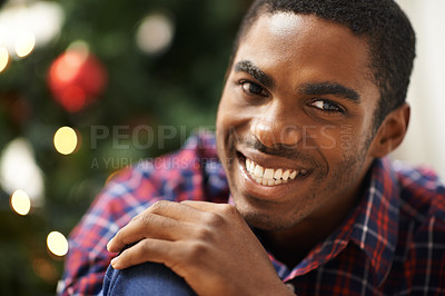 Buy stock photo Man, portrait and smile in home on christmas for celebration, holiday and festive spirit in living room. African person, face and happy on xmas with relax, confidence and vacation in lounge of house