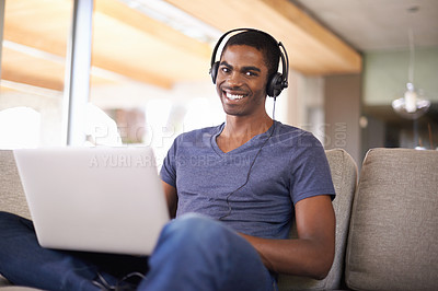 Buy stock photo Man, portrait and music with laptop on couch for internet streaming, podcast or online research with smile. Student, black person or technology with headphones for relax, studying or learning in home