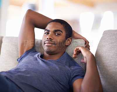 Buy stock photo Man, portrait and smile on sofa with relax in living room of home with comfort, confidence or weekend. Student, african person and happiness with face on couch in lounge for rest, day off or wellness