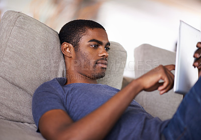 Buy stock photo Home, relax and black man with tablet, typing and connection with social media and internet. African person, apartment and guy with technology or digital app with website information or entertainment