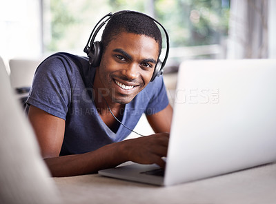 Buy stock photo Man, portrait and music with laptop on sofa for internet streaming, podcast or online research with smile. Student, black person and technology with headphones for relax, studying or learning in home
