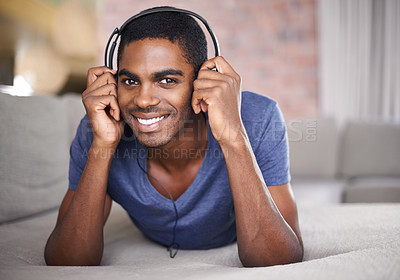 Buy stock photo Man, portrait and happy with music on sofa for audio streaming, podcast or headset in living room of home. Student, black person or face with headphones for relax, radio subscription or rest on couch