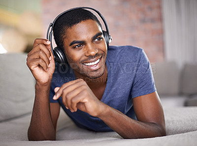 Buy stock photo Man, portrait and smile with music on sofa for audio streaming, podcast or headset in living room of home. Student, black person or face with headphones for relax, radio subscription or rest on couch