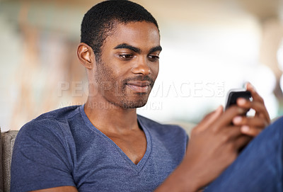 Buy stock photo Home, relax and black man with smartphone, typing and connection with social media and internet. African person, apartment and guy with cellphone and digital app with mobile user and online reading