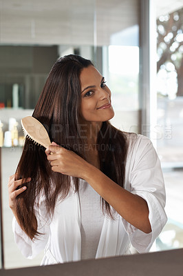 Buy stock photo A lovely young woman applying makeup to her flawless skin in the mirror