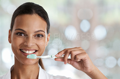 Buy stock photo Portrait of a smiling woman holding a toothbrush
