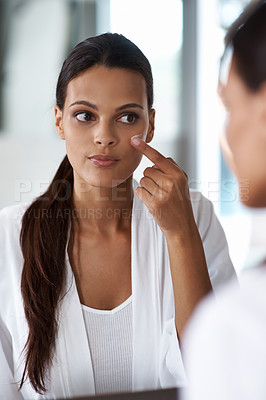 Buy stock photo Woman, mirror and beauty cream, skincare or cosmetics for facial routine and dermatology wellness. Young model or person applying moisturizer and product for eye care, sunscreen and makeup at home