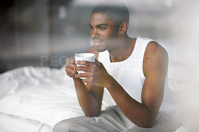Buy stock photo Black man, thinking and morning with coffee in bed for breakfast, start or ambition at home. Young African or male person in wonder, thought or relax with mug, cappuccino or cup of tea in the bedroom