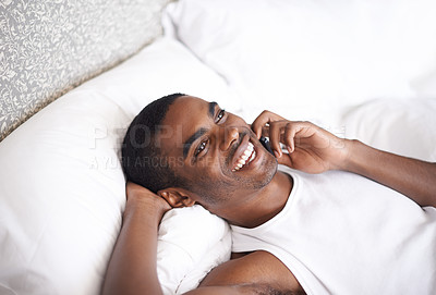 Buy stock photo Call, black man and laughing with phone in bed for funny conversation or communication at home. Face of African male person with smile on mobile smartphone for fun discussion or relax in the bedroom