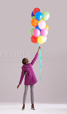 Buy stock photo Balloon, color and black woman in studio for birthday, celebration and present. Happy, excited and wow with isolated person smile with inflatable for party, gift and surprise on gray background