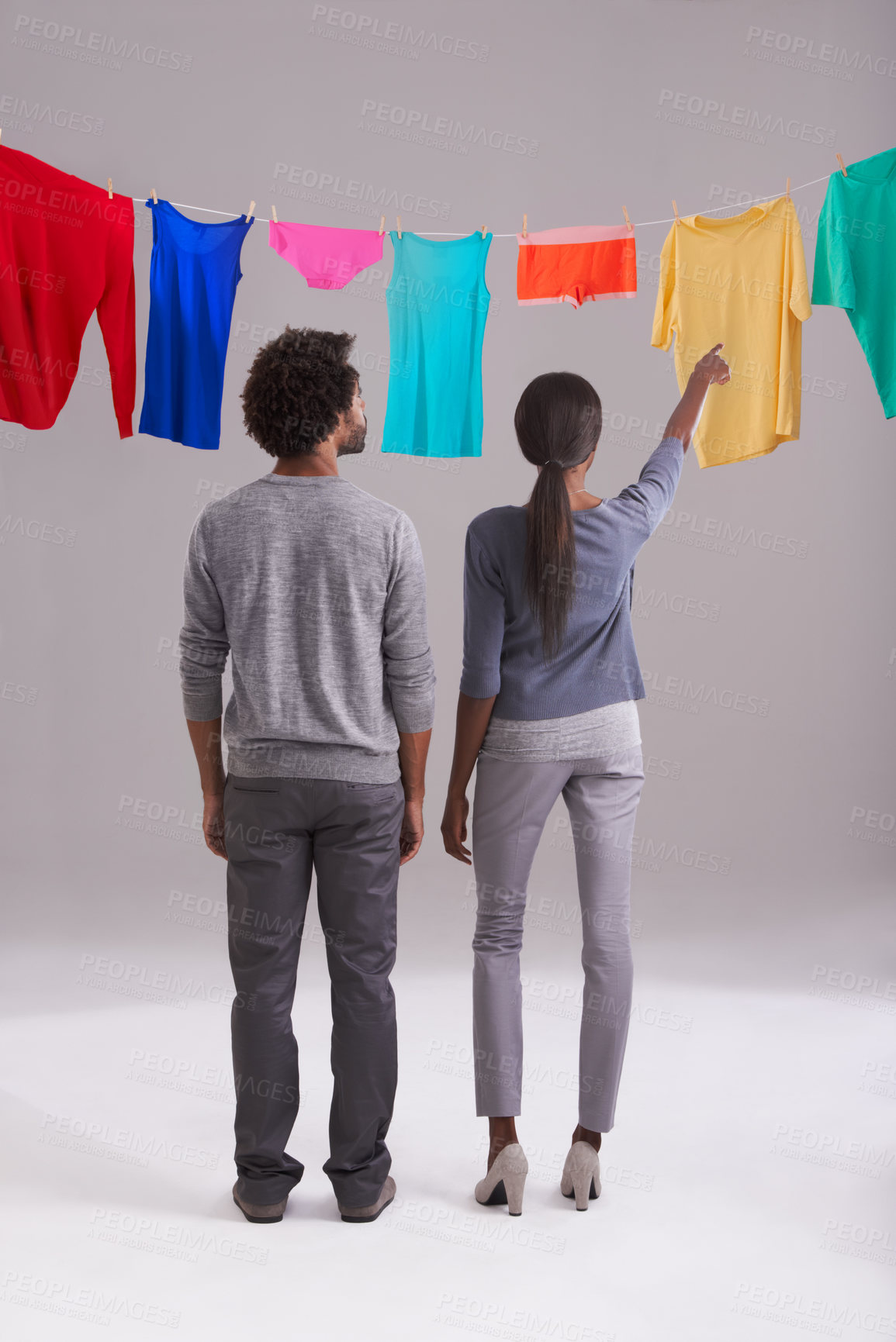 Buy stock photo Laundry, choice and clothing of couple with back view in studio for hygiene, housework, washing in white background. Domestic, black man and woman for household task, clean or fresh fabric on line