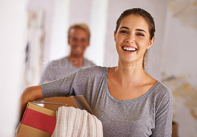 Buy stock photo Portrait of a young woman holding a box on moving day