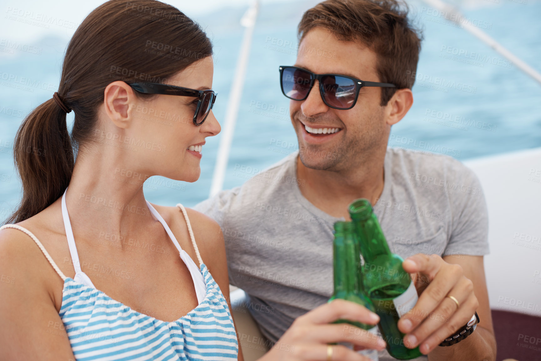 Buy stock photo Smile, couple and toast with alcohol on yacht at sea in celebration of vacation, travel or summer holiday on ship. Man, woman or cheers with beer on boat outdoor for journey, cruise or drink at party