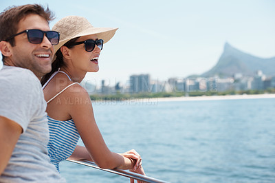 Buy stock photo Shot of an attractive young couple enjoying a boat ride together