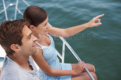 Buy stock photo Happy couple, boat and romantic cruise for honeymoon, pointing and looking at ocean horizon. Smile, yacht and  luxury on the water transportation, holiday and travel in Bora Bora for tourism  