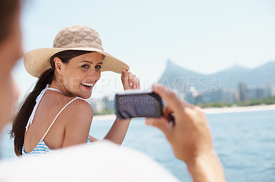 Buy stock photo Happy woman, cellphone and picture on vacation, yacht and cruise on ocean. Social media, photography and honeymoon for married man and wife person, travel or seaside holiday in Hawaii for sunshine 