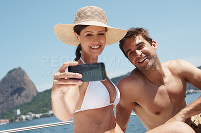 Buy stock photo Couple, yacht and phone selfie on ocean for luxury vacation, summer holiday and outdoor adventure together. Travel, happy man and woman smile with photography for social media update, sea and boat.