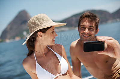 Buy stock photo Yacht, couple and selfie at sea for luxury vacation, summer travel and outdoor adventure together. Relax, happy man and woman smile with photography for social media update, ocean and boat ride.