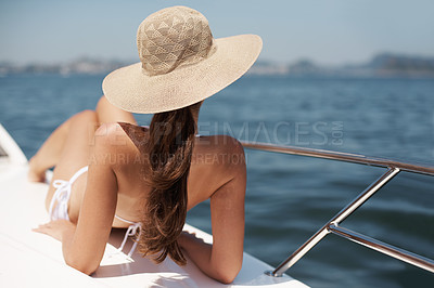 Buy stock photo Boat, woman and relax at ocean on vacation, holiday and back for summer travel. Yacht, rear view or person on ship for cruise, adventure or journey at sea in bikini with hat outdoor on transportation