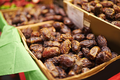 Buy stock photo Harvest, natural and bunch of organic dates for nutrition, health and wellness diet snack. Sustainable, farmers market and dried fruit for vitamins, digestion or fiber on display in grocery store. 