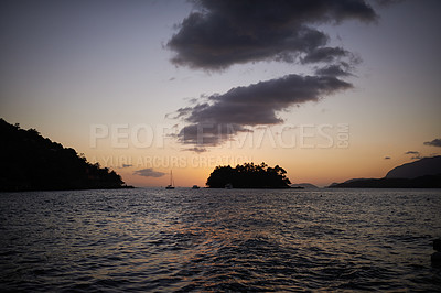 Buy stock photo A small island in the water at dusk