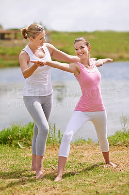 Buy stock photo Women, yoga class and help with exercise outdoor for health, wellness and healing with coach. Fitness, pilates and stretching muscle for workout in park or garden, personal trainer and balance