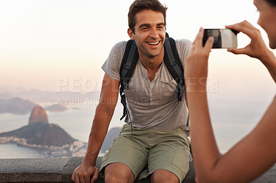 Buy stock photo A young tourist having his picture taking while backpacking
