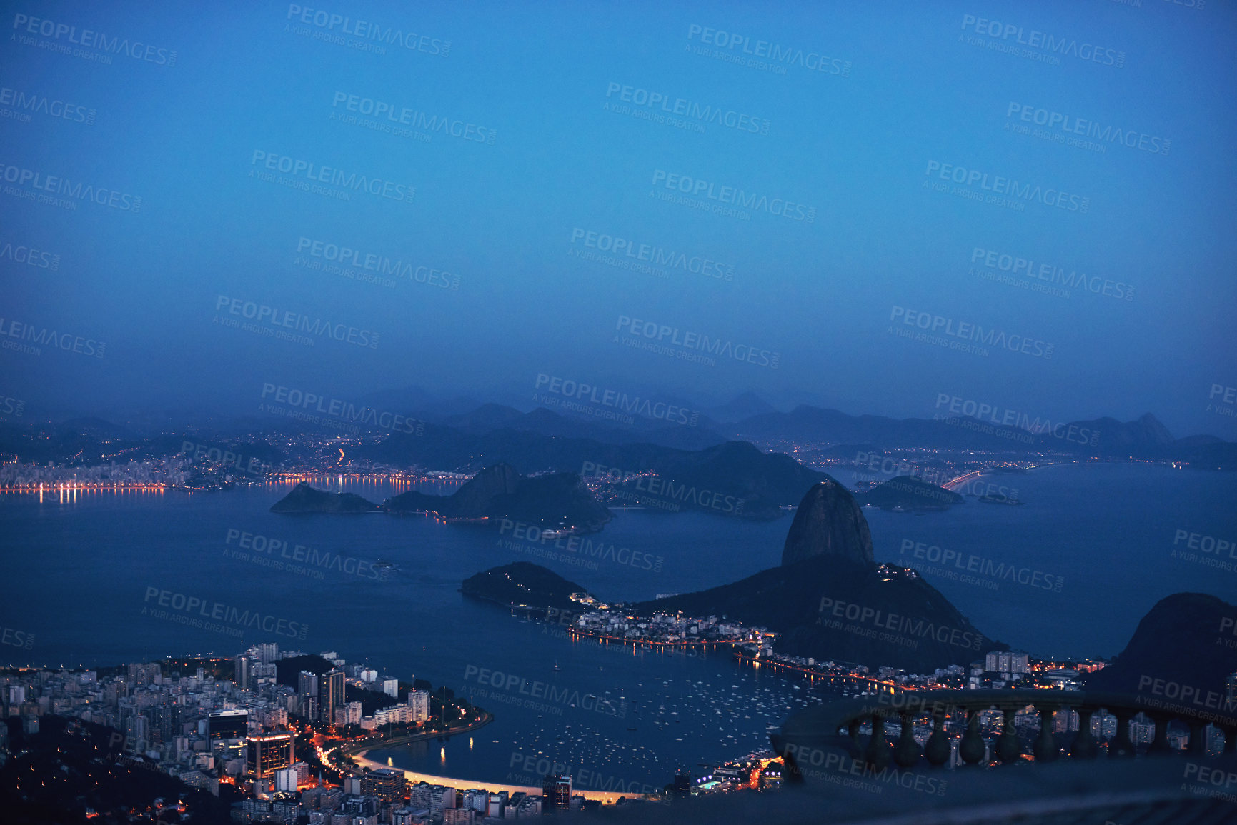 Buy stock photo Aerial, night and city skyline by ocean, mountains and landscape view of urban buildings with lights. Drone, cityscape or coastline in rio brazil for holiday, tourism and travel destination by sea