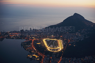 Buy stock photo Mountain, city and lights at night with ocean or highway in urban landscape of Cape Town. Cityscape, drone or aerial view of hill on holiday or travel on vacation with sunset on sea or horizon