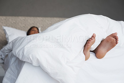 Buy stock photo Tired, feet and woman in bed sleeping, home and white duvet for bedding , lazy and exhausted. Morning, bedroom and female person on day off to relax in apartment, rest and cosy with blanket and dream
