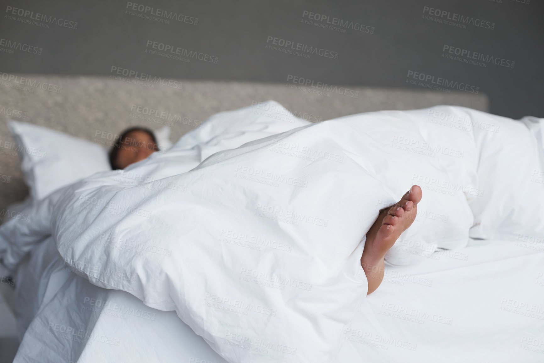 Buy stock photo Lazy, feet and woman in bedroom sleeping, house and white duvet for bedding, nap and exhausted. Morning, dream and female person on day off to relax in apartment, rest and cosy with blanket on bed