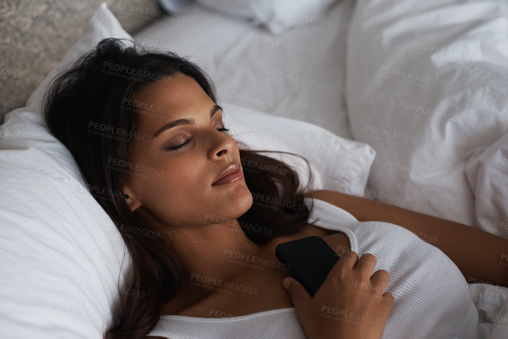 Buy stock photo Night, sleep and woman on bed with phone waiting for call, tired and fatigue for girl in home. Female person, peace and relax in bedroom with mobile for communication, contact and app to connect