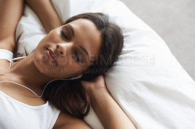 Buy stock photo Woman, sleep and bed with earphones for music, listening to relax in morning at home for peace or rest. Female person, comfortable and lay in pillow, tired and calm in house for wellness close up.