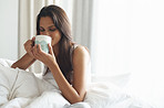 Savoring her morning coffee in bed